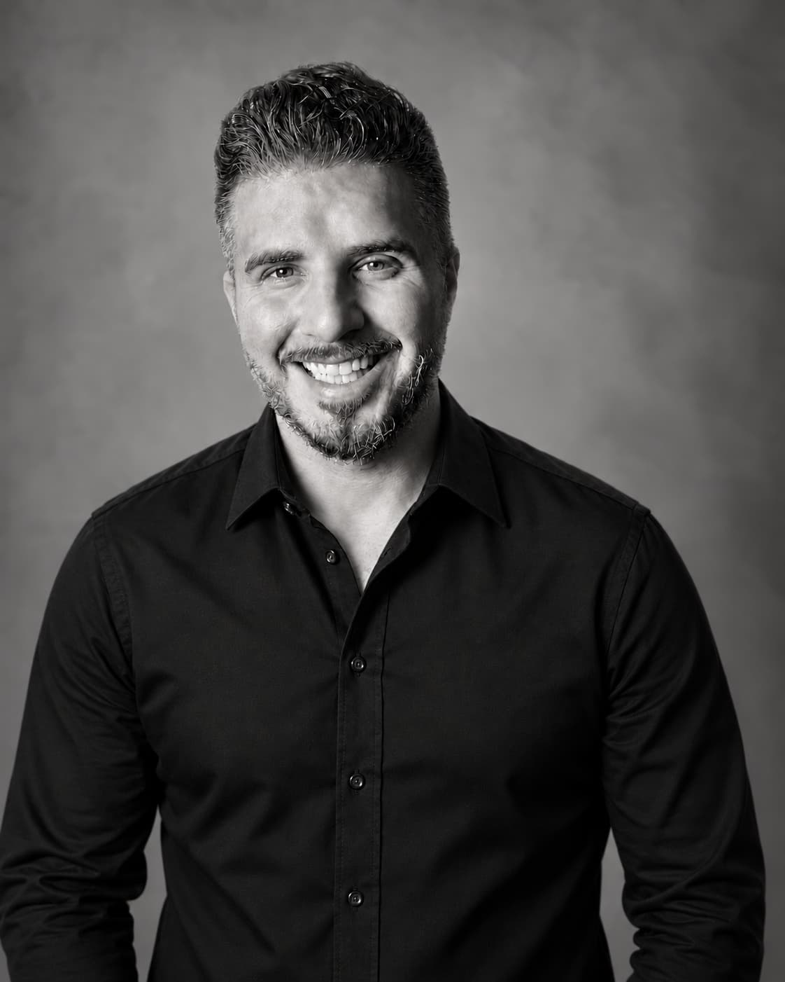 Dr. Marcus Boudreaux in a black dress shirt
